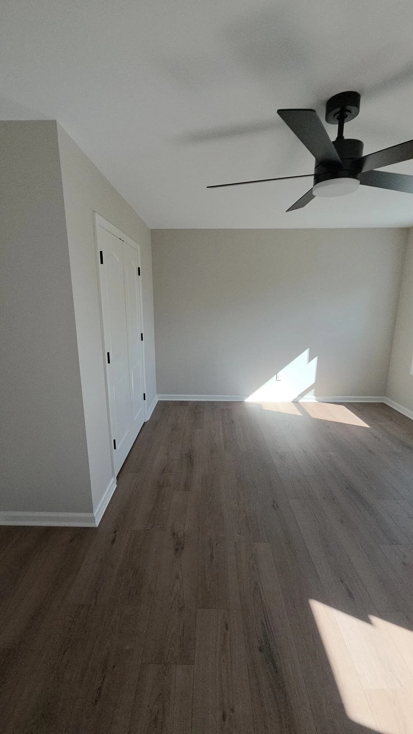 Attic-level addition landing with modern ceiling fan in Newnan, GA